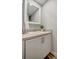 Clean bathroom with white vanity, a large mirror and wood-look floors at 435 30Th W Ave # D309, Bradenton, FL 34205