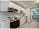 Modern kitchen with white cabinets, stainless steel appliances, and quartz countertops at 435 30Th W Ave # D309, Bradenton, FL 34205