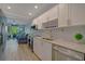 Modern kitchen with white cabinets, stainless steel appliances, and quartz countertops at 435 30Th W Ave # D309, Bradenton, FL 34205