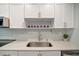 Modern kitchen with white cabinets, stainless steel sink, and quartz countertops at 435 30Th W Ave # D309, Bradenton, FL 34205