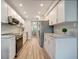 Modern kitchen with white cabinets, stainless steel appliances, and quartz countertops at 435 30Th W Ave # D309, Bradenton, FL 34205