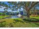 Serene lakefront view with lush landscaping at 435 30Th W Ave # D309, Bradenton, FL 34205