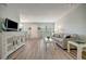 Living room boasts hardwood floors, comfy sofa, large TV, and white cabinet at 435 30Th W Ave # D309, Bradenton, FL 34205