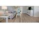 Living area with a sofa, wicker furniture, and wood-look flooring at 435 30Th W Ave # D309, Bradenton, FL 34205
