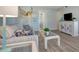 Living room features a striped sofa, wicker coffee table, and decorative angel statue at 435 30Th W Ave # D309, Bradenton, FL 34205