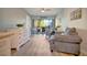 Bright living room with comfy seating, large window, and access to balcony at 435 30Th W Ave # D309, Bradenton, FL 34205