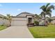 House exterior with a two car garage and manicured lawn at 4506 Lindever Ln, Palmetto, FL 34221