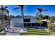 Contemporary waterfront home with palm trees and circular driveway at 501 Outrigger Ln, Longboat Key, FL 34228