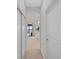 Hallway with carpet and doors leading to other rooms at 5015 Jagged Cloud Dr, Wimauma, FL 33598