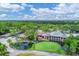 Aerial view of golf course with clubhouse and pond at 5128 Marsh Field Ln # 129, Sarasota, FL 34235