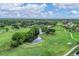 Aerial view of a golf course with a waterway and lush landscaping at 5128 Marsh Field Ln # 129, Sarasota, FL 34235