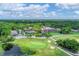 Aerial view of golf course with clubhouse and lush green fairways at 5128 Marsh Field Ln # 129, Sarasota, FL 34235