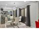 Elegant dining area with glass table, modern chandelier, and patio access at 5128 Marsh Field Ln # 129, Sarasota, FL 34235