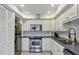 Updated kitchen with stainless steel appliances and white cabinets at 5128 Marsh Field Ln # 129, Sarasota, FL 34235