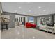 Spacious living room with gray walls, modern furniture, and large TV at 5128 Marsh Field Ln # 129, Sarasota, FL 34235