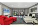Bright living room features a comfy sectional sofa, red accent chairs, and sliding doors to a patio at 5128 Marsh Field Ln # 129, Sarasota, FL 34235