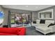 Open living room with gray walls, white sectional, red chairs and patio access at 5128 Marsh Field Ln # 129, Sarasota, FL 34235