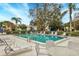 Community pool with lounge chairs at 5128 Marsh Field Ln # 129, Sarasota, FL 34235