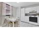 Bright eat-in kitchen with white cabinetry and appliances at 542 Lakeside Dr # 542, Bradenton, FL 34210