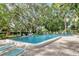 Community pool with lounge chairs and lush landscaping at 542 Lakeside Dr # 542, Bradenton, FL 34210
