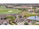 Aerial view of community, showcasing villas, golf course, and pond at 5518 Palmer Cir # 105, Bradenton, FL 34211