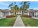 Building exterior with walkway and lush landscaping at 5518 Palmer Cir # 105, Bradenton, FL 34211