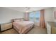 Spacious bedroom with soft pink bedding and large windows at 5750 Archipelago St St, Nokomis, FL 34275