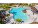 Community pool with surrounding lounge chairs and palm trees at 5750 Archipelago St St, Nokomis, FL 34275