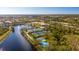 Aerial view of community with tennis courts, pool, and lake at 5839 Helicon Pl, Sarasota, FL 34238