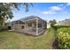 Screened patio and lush green backyard with beautiful landscaping at 5839 Helicon Pl, Sarasota, FL 34238