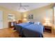 Bedroom with two twin beds, light yellow walls, and wood floors at 5839 Helicon Pl, Sarasota, FL 34238