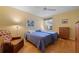 Bedroom with two twin beds, light yellow walls, and wood floors at 5839 Helicon Pl, Sarasota, FL 34238