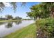 Scenic view of a peaceful canal with lush green landscaping at 5839 Helicon Pl, Sarasota, FL 34238