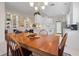 Spacious dining area with a wooden table and chairs, adjacent to kitchen at 5839 Helicon Pl, Sarasota, FL 34238