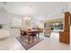 Bright dining area with chandelier and view of living room and kitchen at 5839 Helicon Pl, Sarasota, FL 34238