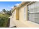 Side view of the house showcasing clean lines and landscaping at 5839 Helicon Pl, Sarasota, FL 34238