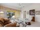 Gathering room features sliding doors to screened patio and view of canal at 5839 Helicon Pl, Sarasota, FL 34238