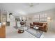 Bright living room with tile floors, comfortable seating, and access to kitchen at 5839 Helicon Pl, Sarasota, FL 34238