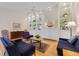 Bright living room features built-in shelving, comfortable seating, and hardwood floors at 5839 Helicon Pl, Sarasota, FL 34238