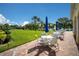 Community patio with tables, chairs, and lake view at 5839 Helicon Pl, Sarasota, FL 34238