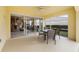 Bright screened patio with view of the living room and backyard at 5839 Helicon Pl, Sarasota, FL 34238