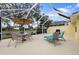 Spacious screened patio with seating area overlooking the canal at 5839 Helicon Pl, Sarasota, FL 34238