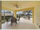 Spacious screened patio with seating area, overlooking a tranquil backyard at 5839 Helicon Pl, Sarasota, FL 34238