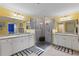 Elegant bathroom with double vanity, granite countertops, and glass shower at 6065 Worsham Ln # 104, Bradenton, FL 34211