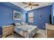 Guest bedroom with blue walls, a queen-size bed and coastal decor at 6065 Worsham Ln # 104, Bradenton, FL 34211