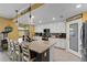 Well-equipped kitchen with white cabinets, granite island, and breakfast bar at 6065 Worsham Ln # 104, Bradenton, FL 34211