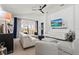 Bright living room with white sofas and a large TV at 6247 Champions Row St, Bradenton, FL 34210