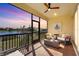 Relaxing screened porch overlooking a lake, featuring comfortable seating and sunset views at 6247 Champions Row St, Bradenton, FL 34210