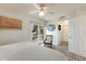 Bedroom with water view, ceiling fan, and brick-style flooring at 6250 Holmes Blvd # 71, Holmes Beach, FL 34217