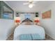 Bedroom with built-in shelves and ceiling fan at 6250 Holmes Blvd # 71, Holmes Beach, FL 34217